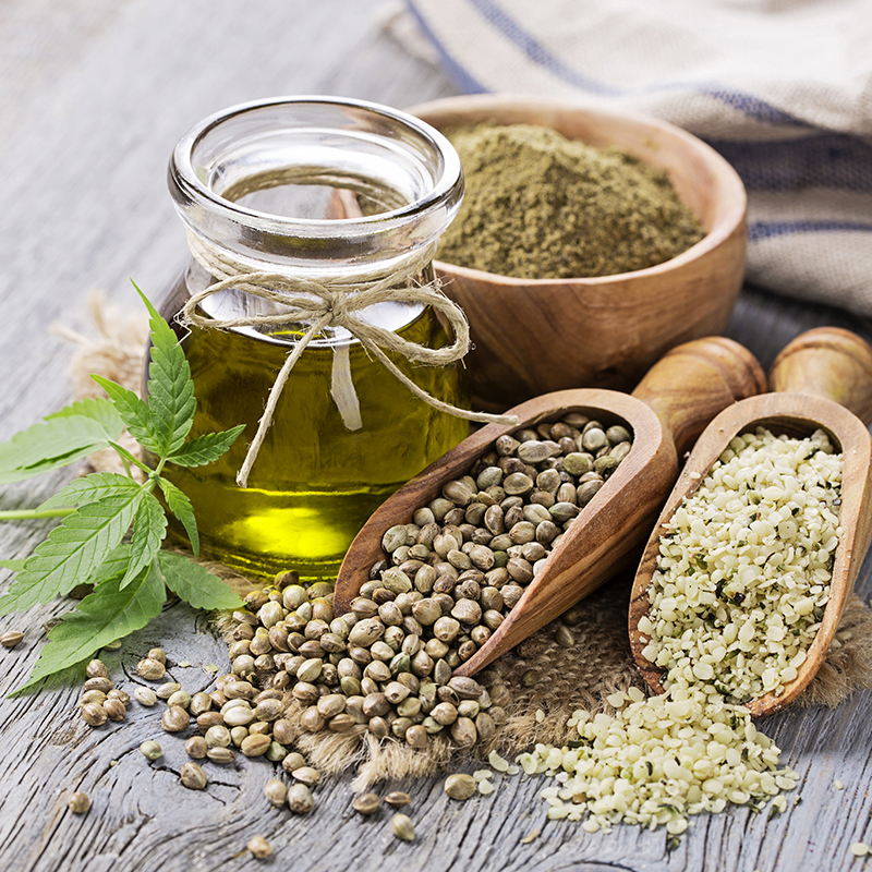 Hemp oil in a glass jar and hemp seeds